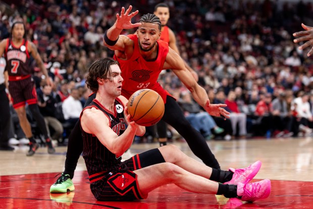 Chicago Bulls guard Josh Giddey passes the ball to a teammate as Portland Trail Blazers forward Toumani Camara (33) defends him in the first half of a game against the Portland Trail Blazers at the United Center in Chicago on Feb. 26, 2026. (Josh Boland/Chicago Tribune)
