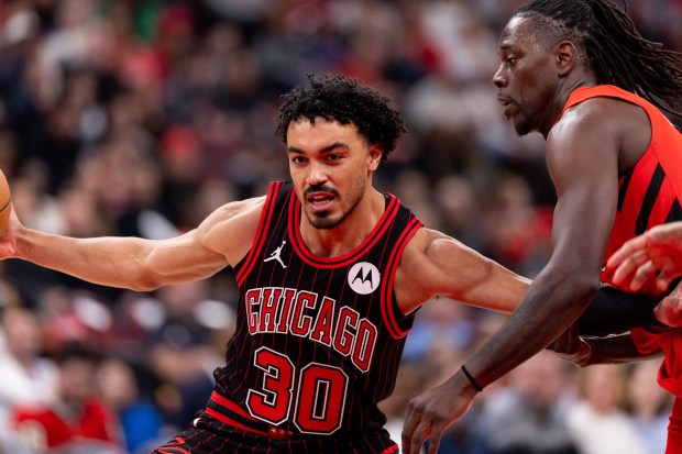 Chicago Bulls guard Tre Jones (30) carries the ball against Portland Trail Blazers guard Jrue Holiday in the first half of a game against the Portland Trail Blazers at the United Center in Chicago on Feb. 26, 2026. (Josh Boland/Chicago Tribune)