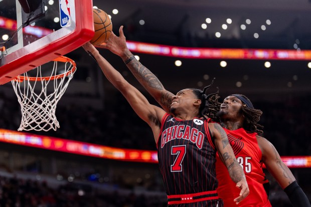 Chicago Bulls guard Rob Dillingham (7) shoots a layup as Portland Trail Blazers center Robert Williams III (35) attempts a block in the first half of a game against the Portland Trail Blazers at the United Center in Chicago on Feb. 26, 2026. (Josh Boland/Chicago Tribune)