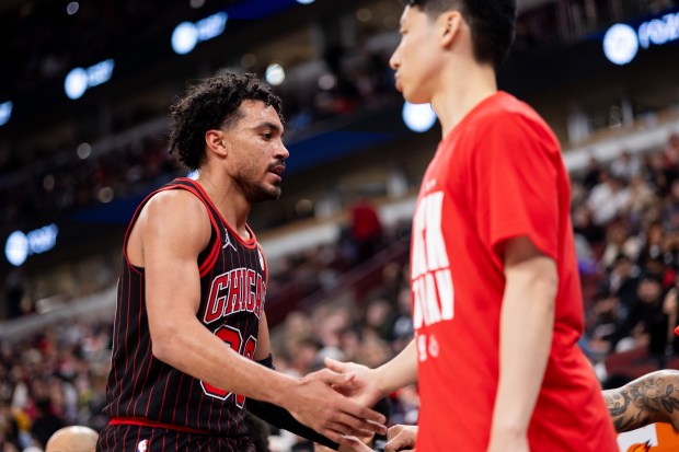 Chicago Bulls guard Tre Jones high fives guard Yuki Kawamura in the second half of a game against the Portland Trail Blazers at the United Center in Chicago on Feb. 26, 2026. (Josh Boland/Chicago Tribune)
