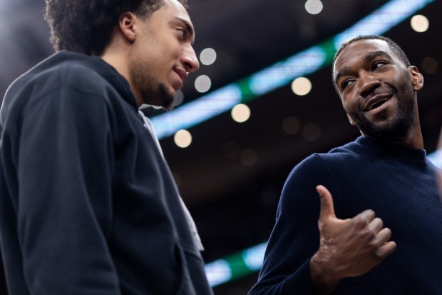 Bulls forward Noa Essengue, left, speaks with forward Patrick Williams in the second half of a game against the Trail Blazers on Feb. 26, 2026, at the United Center. (Josh Boland/Chicago Tribune)