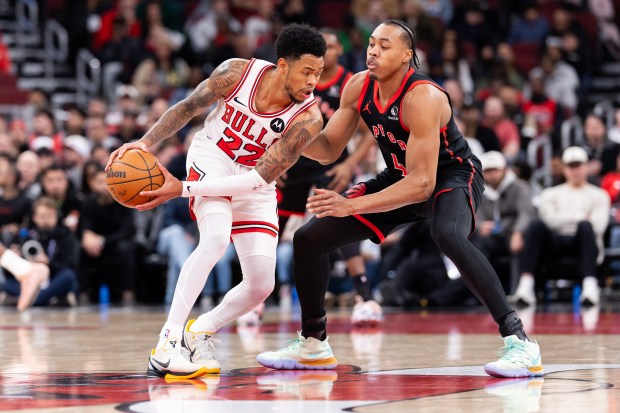Chicago Bulls guard Anfernee Simons (22) carries the ball against Toronto Raptors forward Scottie Barnes (4) in the first half of a game against the Toronto Raptors at the United Center in Chicago on Feb. 19, 2026. (Josh Boland/Chicago Tribune)