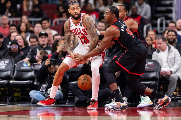 Chicago Bulls center Nick Richards (13) has the ball stolen by Toronto Raptors forward RJ Barrett (9) in the first half of a game against the Toronto Raptors at the United Center in Chicago on Feb. 19, 2026. (Josh Boland/Chicago Tribune)