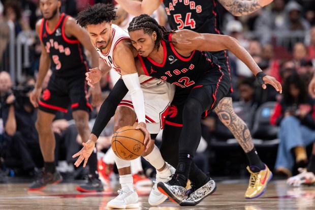 Chicago Bulls guard Tre Jones is fouled by Toronto Raptors forward Collin Murray-Boyles (12) in the first half of a game against the Toronto Raptors at the United Center in Chicago on Feb. 19, 2026. (Josh Boland/Chicago Tribune)
