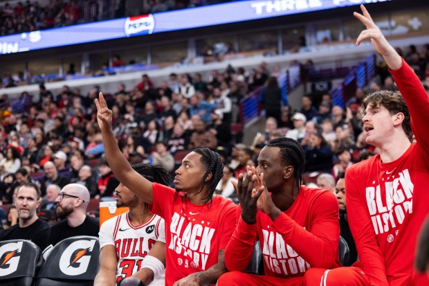 Chicago Bulls guard Jaden Ivey (31), guard Rob Dillingham, forward Leonard Miller and center Lachlan Olbrich react to a 3-pointer scored in the second half of a game against the Toronto Raptors at the United Center in Chicago on Feb. 19, 2026. (Josh Boland/Chicago Tribune)