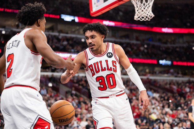 Chicago Bulls guard Collin Sexton (2) and guard Tre Jones (30) celebrate a scored basket in the second half of a game against the Toronto Raptors at the United Center in Chicago on Feb. 19, 2026. (Josh Boland/Chicago Tribune)