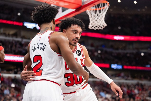 Chicago Bulls guard Collin Sexton (2) and guard Tre Jones (30) celebrate a scored basket in the second half of a game against the Toronto Raptors at the United Center in Chicago on Feb. 19, 2026. (Josh Boland/Chicago Tribune)