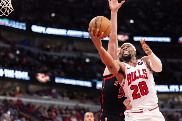 Chicago Bulls forward Guerschon Yabusele (28) goes for a layup over Toronto Raptors forward Sandro Mamukelashvili in the second half of a game against the Toronto Raptors at the United Center in Chicago on Feb. 19, 2026. (Josh Boland/Chicago Tribune)
