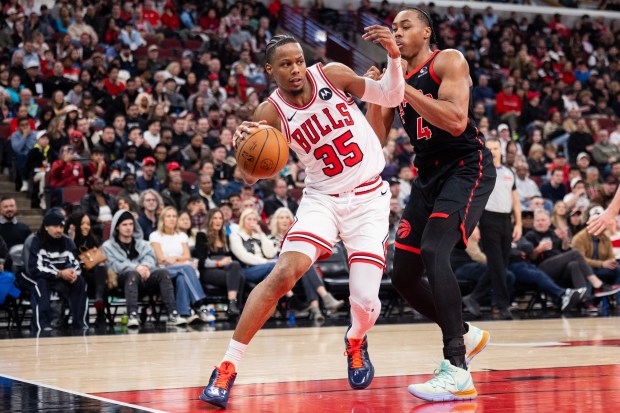 Chicago Bulls forward Isaac Okoro (35) makes a move around Toronto Raptors forward Scottie Barnes (4) in the second half of a game against the Toronto Raptors at the United Center in Chicago on Feb. 19, 2026. (Josh Boland/Chicago Tribune)