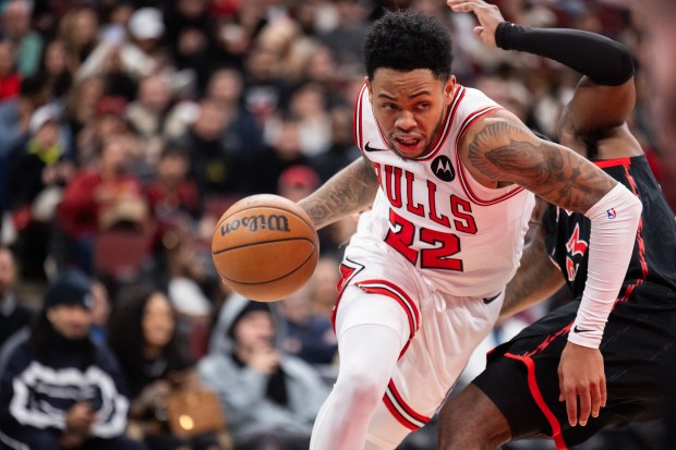 Chicago Bulls guard Anfernee Simons (22) makes a move around Toronto Raptors guard Jamal Shead in the second half of a game against the Toronto Raptors at the United Center in Chicago on Feb. 19, 2026. (Josh Boland/Chicago Tribune)