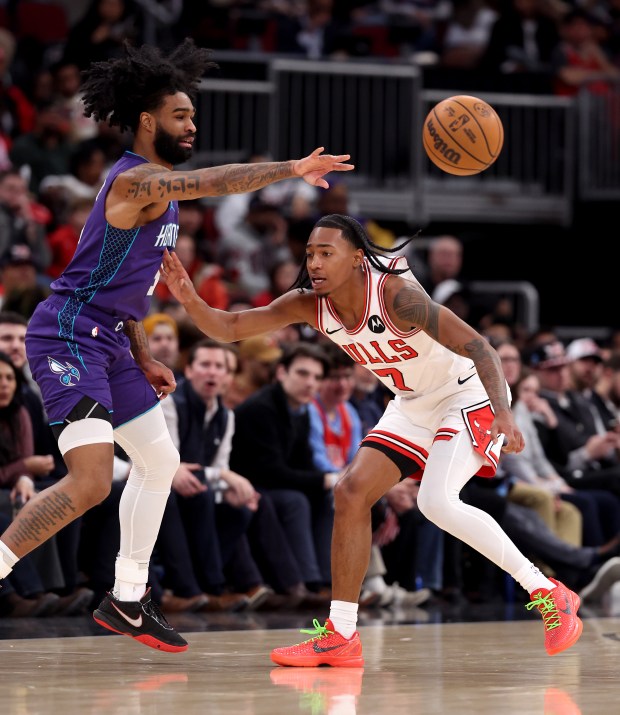 Charlotte Hornets guard Coby White (3) passes the ball by Chicago Bulls guard Rob Dillingham (7) in the second half of a game at the United Center in Chicago on Feb. 24, 2026. (Chris Sweda/Chicago Tribune)