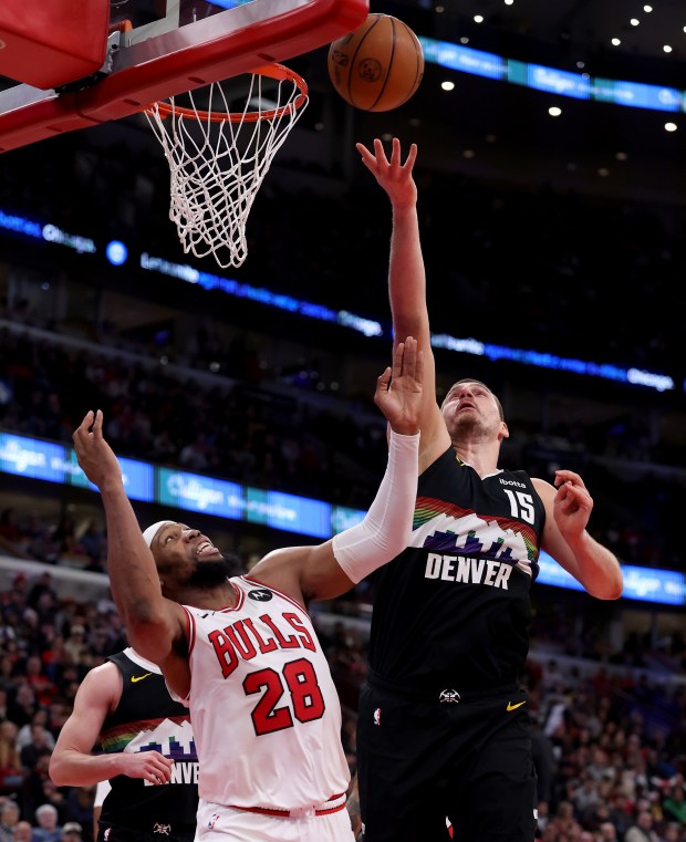 Chicago Bulls center/forward Guerschon Yabusele (28) and Denver Nuggets center Nikola Jokić (15) fight for a rebound in the first half of a game at the United Center in Chicago on Feb. 7, 2026. (Chris Sweda/Chicago Tribune)