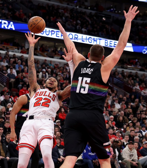 Chicago Bulls guard Anfernee Simons (22) tries to put up a shot as Denver Nuggets center Nikola Jokić (15) defends in the second half of a game at the United Center in Chicago on Feb. 7, 2026. (Chris Sweda/Chicago Tribune)