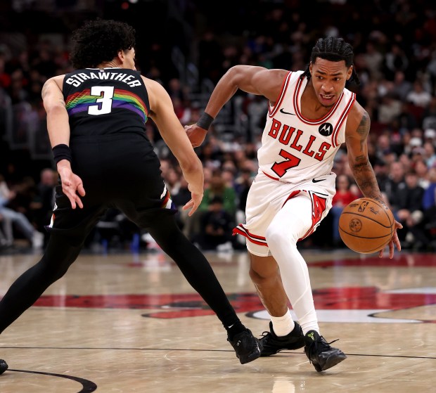 Chicago Bulls guard Rob Dillingham (7) makes a move on Denver Nuggets guard Julian Strawther (3) in the second half of a game at the United Center in Chicago on Feb. 7, 2026. (Chris Sweda/Chicago Tribune)