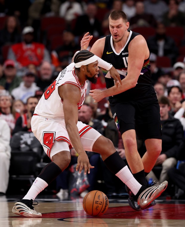 Denver Nuggets center Nikola Jokić (15) defends against Chicago Bulls center/forward Guerschon Yabusele (28) in the first half of a game at the United Center in Chicago on Feb. 7, 2026. (Chris Sweda/Chicago Tribune)