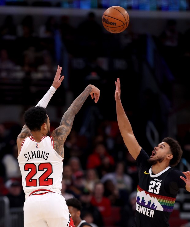 Chicago Bulls guard Anfernee Simons (22) shoots over Denver Nuggets forward Cameron Johnson (23) in the first half of a game at the United Center in Chicago on Feb. 7, 2026. (Chris Sweda/Chicago Tribune)