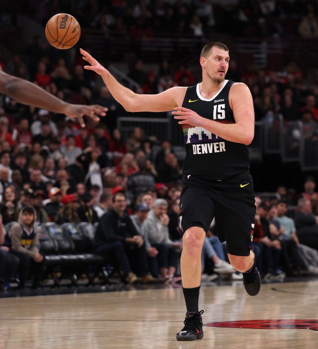 Denver Nuggets center Nikola Jokić (15) makes a no-look pass in the first half of a game against the Chicago Bulls at the United Center in Chicago on Feb. 7, 2026. (Chris Sweda/Chicago Tribune)