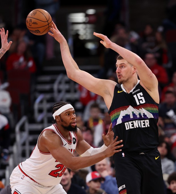Denver Nuggets center Nikola Jokić (15) passes over Chicago Bulls center/forward Guerschon Yabusele (28) in the second half of a game at the United Center in Chicago on Feb. 7, 2026. (Chris Sweda/Chicago Tribune)