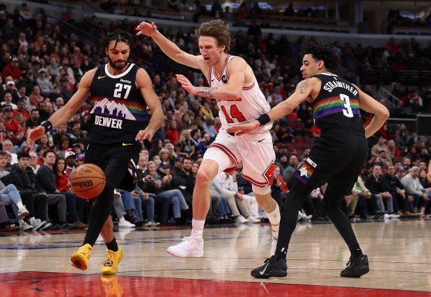 Chicago Bulls forward Matas Buzelis (14) loses the ball between Denver Nuggets guard Jamal Murray (27) and guard Julian Strawther (3) in the second half of a game at the United Center in Chicago on Feb. 7, 2026. (Chris Sweda/Chicago Tribune)