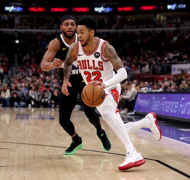 Chicago Bulls guard Anfernee Simons (22) drives on Denver Nuggets guard/forward Bruce Brown (11) in the second half of a game at the United Center in Chicago on Feb. 7, 2026. (Chris Sweda/Chicago Tribune)