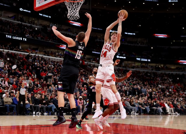 Chicago Bulls forward Matas Buzelis (14) pulls down a rebound over Denver Nuggets center Nikola Jokić (15) in the first half of a game at the United Center in Chicago on Feb. 7, 2026. (Chris Sweda/Chicago Tribune)