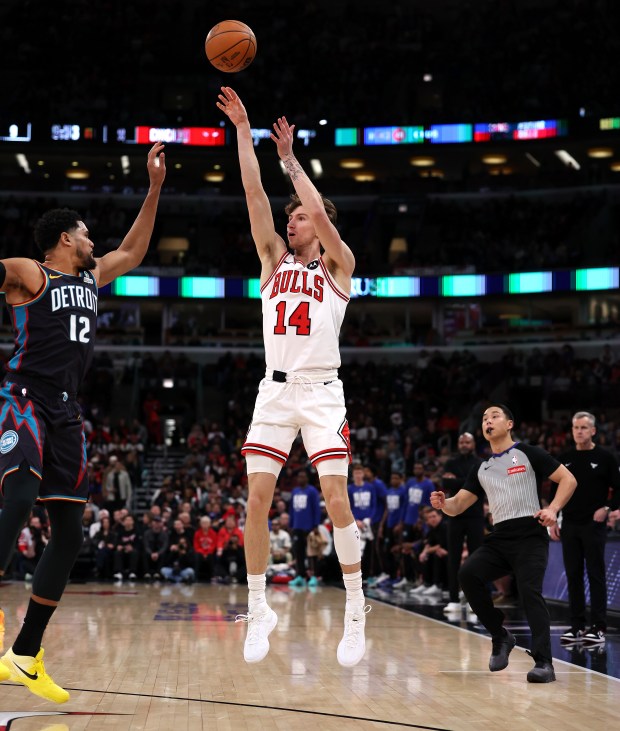 Chicago Bulls forward Matas Buzelis (14) shoots a 3-pointer over Detroit Pistons forward Tobias Harris (12) in the first half of a game at the United Center in Chicago on Feb. 21, 2026. (Chris Sweda/Chicago Tribune)