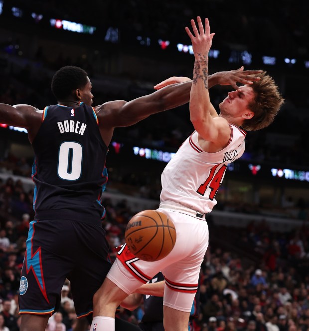 Chicago Bulls forward Matas Buzelis (14) loses the ball while trying to drive through the defense of Detroit Pistons center Jalen Duren (0) in the first half of a game at the United Center in Chicago on Feb. 21, 2026. (Chris Sweda/Chicago Tribune)