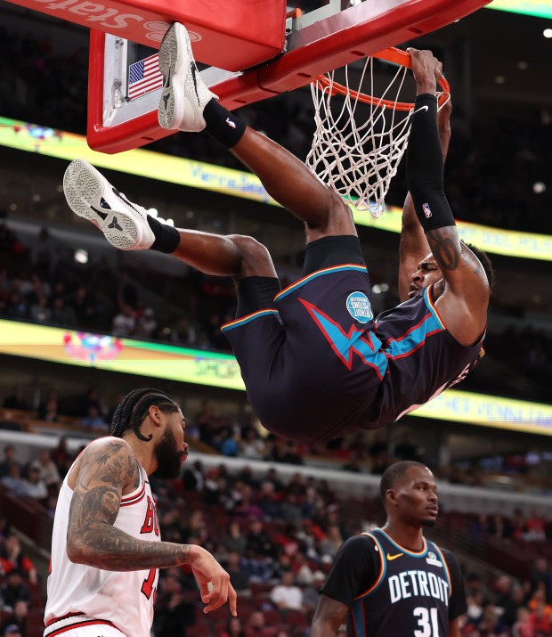 Detroit Pistons forward Paul Reed (7) hangs on the rim after a dunk in the second half of a game against the Chicago Bulls at the United Center in Chicago on Feb. 21, 2026. (Chris Sweda/Chicago Tribune)