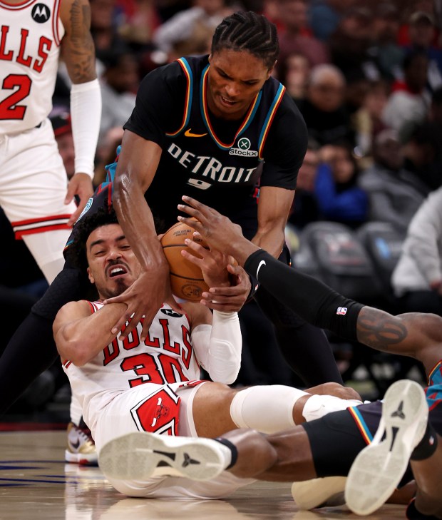 Chicago Bulls guard Tre Jones (30) and Detroit Pistons guard/forward Ausar Thompson (9) battle for a loose ball in the first half of a game at the United Center in Chicago on Feb. 21, 2026. (Chris Sweda/Chicago Tribune)