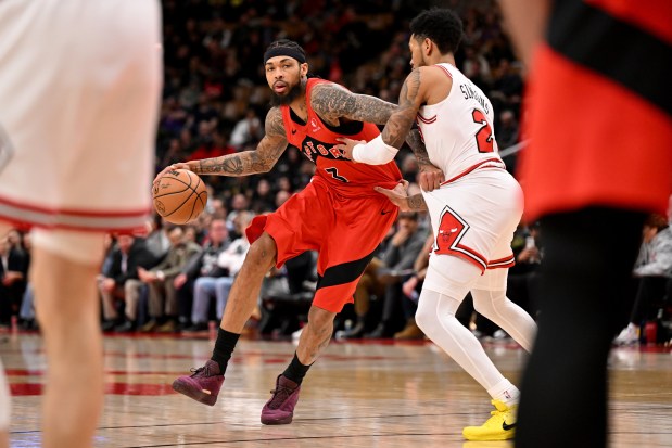 The Bulls' Anfernee Simons, right, defends the Raptors' Brandon Ingram during the second half Thursday, Feb. 5, 2026, in Toronto. (Jon Blacker/The Canadian Press via AP)