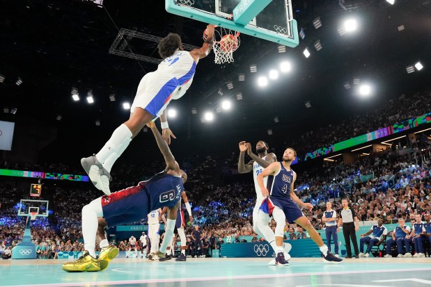 France's Guerschon Yabusele dunks over Team USA's LeBron James during a gold-medal game at the Summer Olympics on Aug. 10, 2024, in Paris. (Mark J. Terrill/AP)