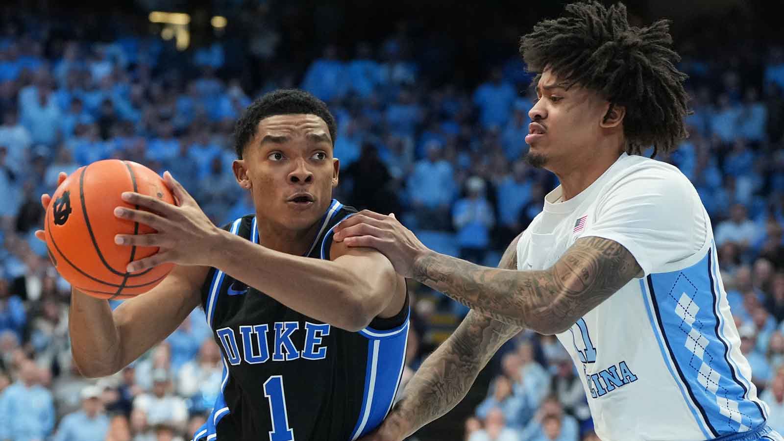 Duke Blue Devils guard Caleb Foster (1) with the ball as North Carolina Tar Heels forward Jonathan Powell (11) defends in the first half at Dean E. Smith Center.