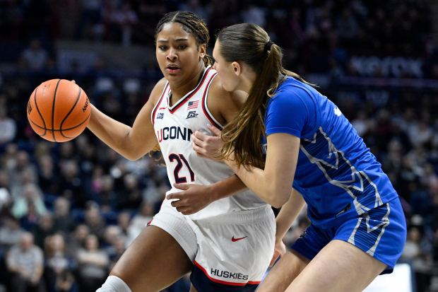 UConn forward Sarah Strong (21) is guarded by Creighton center Elizabeth Gentry in the first half of an NCAA college basketball game, Wednesday, Feb. 11, 2026, in Storrs, Conn. (AP Photo/Jessica Hill)