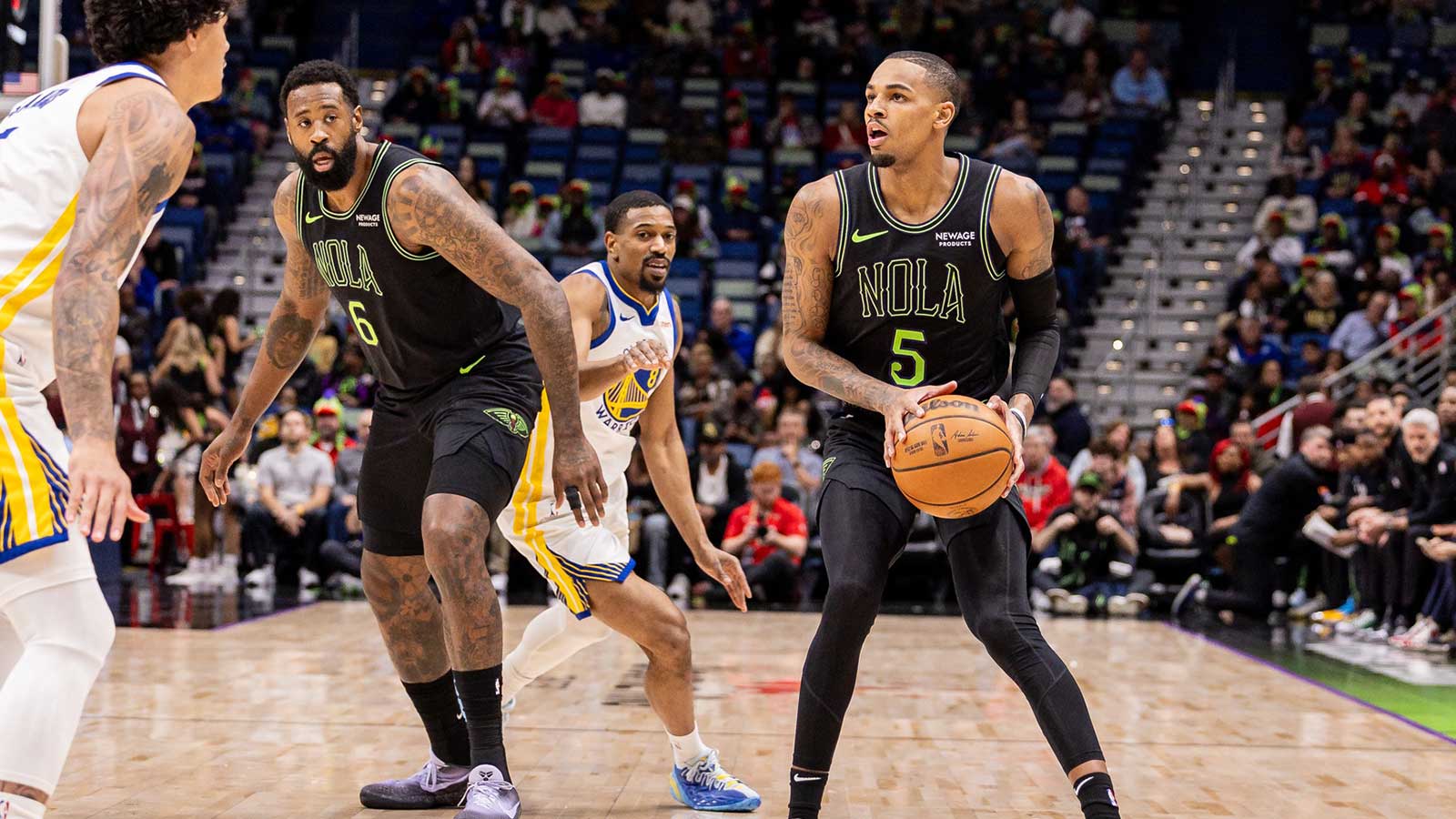 New Orleans Pelicans guard Dejounte Murray (5) shoots a three point basket against Golden State Warriors forward Gui Santos (15) during the first half at Smoothie King Center.