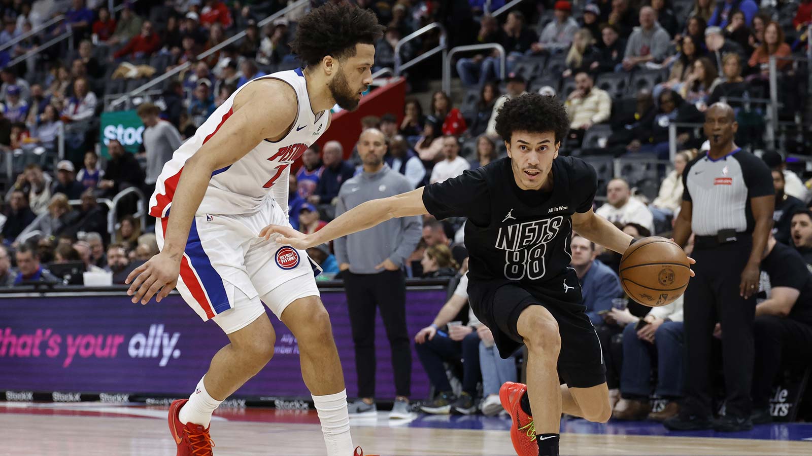 Brooklyn Nets guard Nolan Traore (88) dribbles defended by Detroit Pistons guard Cade Cunningham (2) in the first half at Little Caesars Arena.