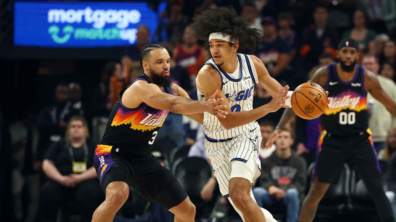 Phoenix Suns forward Dillon Brooks (3) defends against Orlando Magic guard Anthony Black (0) in the first half at Mortgage Matchup Center.