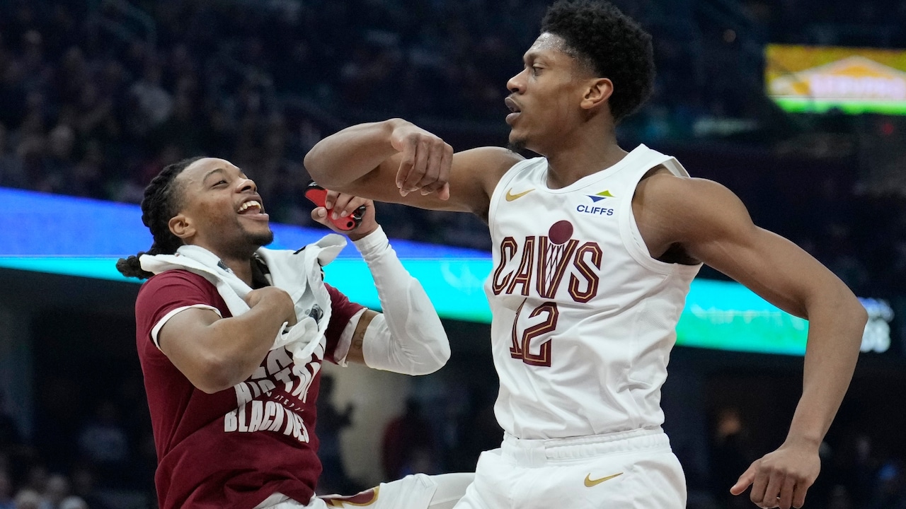 Cleveland Cavaliers forward De'Andre Hunter, right, celebrates with teammate Darius Garland, left, after a basket in the first half of an NBA basketball game against the Minnesota Timberwolves, Monday, Feb. 10, 2025, in Cleveland
