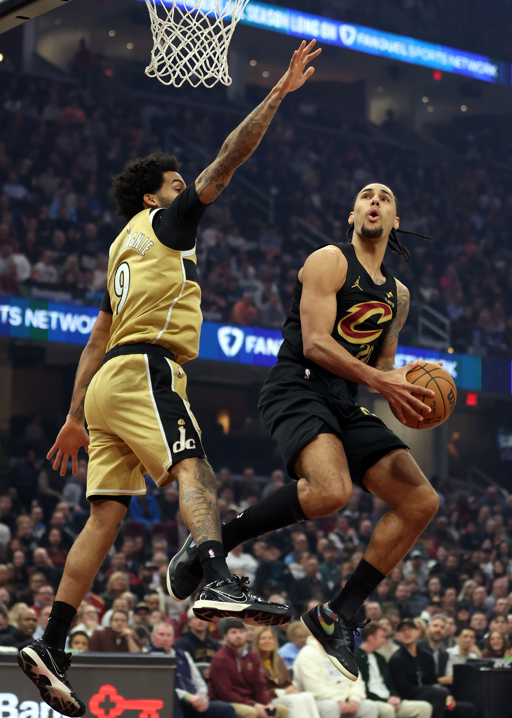 Cleveland Cavaliers guard Jaylon Tyson goes to the rim against Washington Wizards forward Justin Champagnie in the first half of play. 