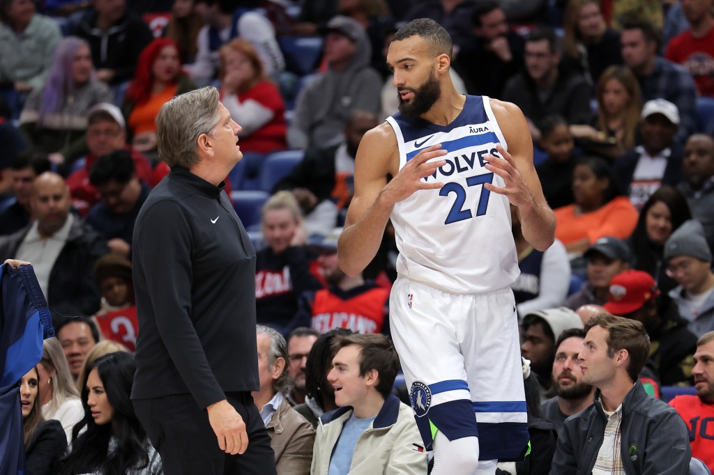 Rudy Gobert (27) and head coach Chris Finch of the Minnesota Timberwolves react during the first half at the Smoothie King Center on December 11, 2023 in New Orleans, Louisiana. 