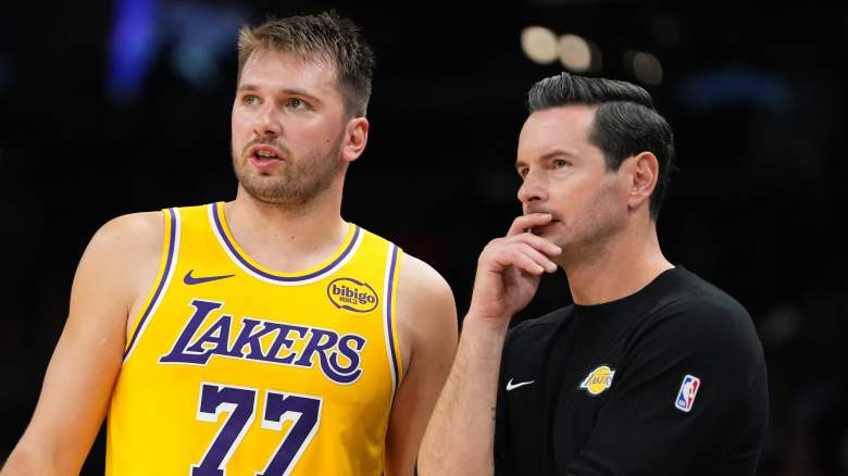 PHOENIX, ARIZONA - OCTOBER 14: Luka Doncic #77 of the Los Angeles Lakers talks with head coach JJ Redick during the first half of the NBA preseason game against the Phoenix Suns at Mortgage Matchup Center on October 14, 2025 in Phoenix, Arizona. NOTE TO USER: User expressly acknowledges and agrees that, by downloading and or using this photograph, User is consenting to the terms and conditions of the Getty Images License Agreement. (Photo by Kelsey Grant/Getty Images)