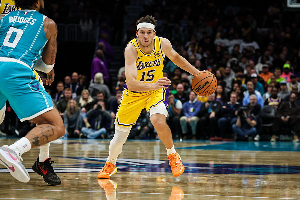 CHARLOTTE, NORTH CAROLINA - NOVEMBER 10: Austin Reaves #15 of the Los Angeles Lakers drives by Miles Bridges #0 of the Charlotte Hornets during the second half of a basketball game at Spectrum Center on November 10, 2025 in Charlotte, North Carolina. NOTE TO USER: User expressly acknowledges and agrees that, by downloading and or using this photograph, User is consenting to the terms and conditions of the Getty Images License Agreement. (Photo by David Jensen/Getty Images)