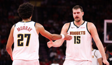 HOUSTON, TEXAS - NOVEMBER 21: Nikola Jokić #15 and Jamal Murray #27 of the Denver Nuggets react du...