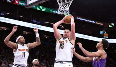 PHOENIX, ARIZONA - NOVEMBER 29: Nikola Jokic #15 of the Denver Nuggets controls a rebound against Oso Ighodaro #11 of the Phoenix Suns during the second half at Mortgage Matchup Center on November 29, 2025 in Phoenix, Arizona. The Nuggets defeated the Suns 130-112. NOTE TO USER: User expressly acknowledges and agrees that, by downloading and or using this photograph, User is consenting to the terms and conditions of the Getty Images License Agreement. (Photo by Chris Coduto/Getty Images)