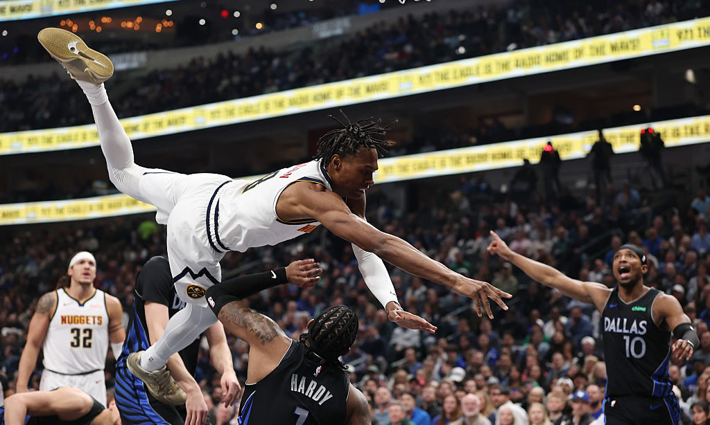 DALLAS, TEXAS - JANUARY 14: Jaden Hardy #1 of the Dallas Mavericks is fouled by Peyton Watson #8 of...