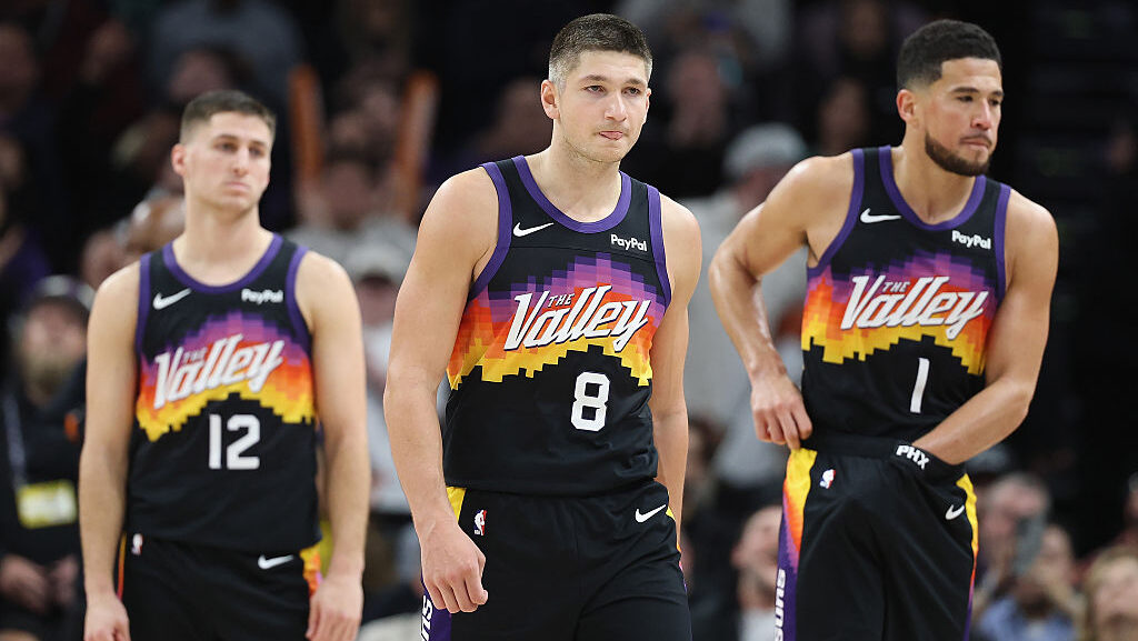 Grayson Allen #8 (C) of the Phoenix Suns with Collin Gillespie #12 and Devin Booker...