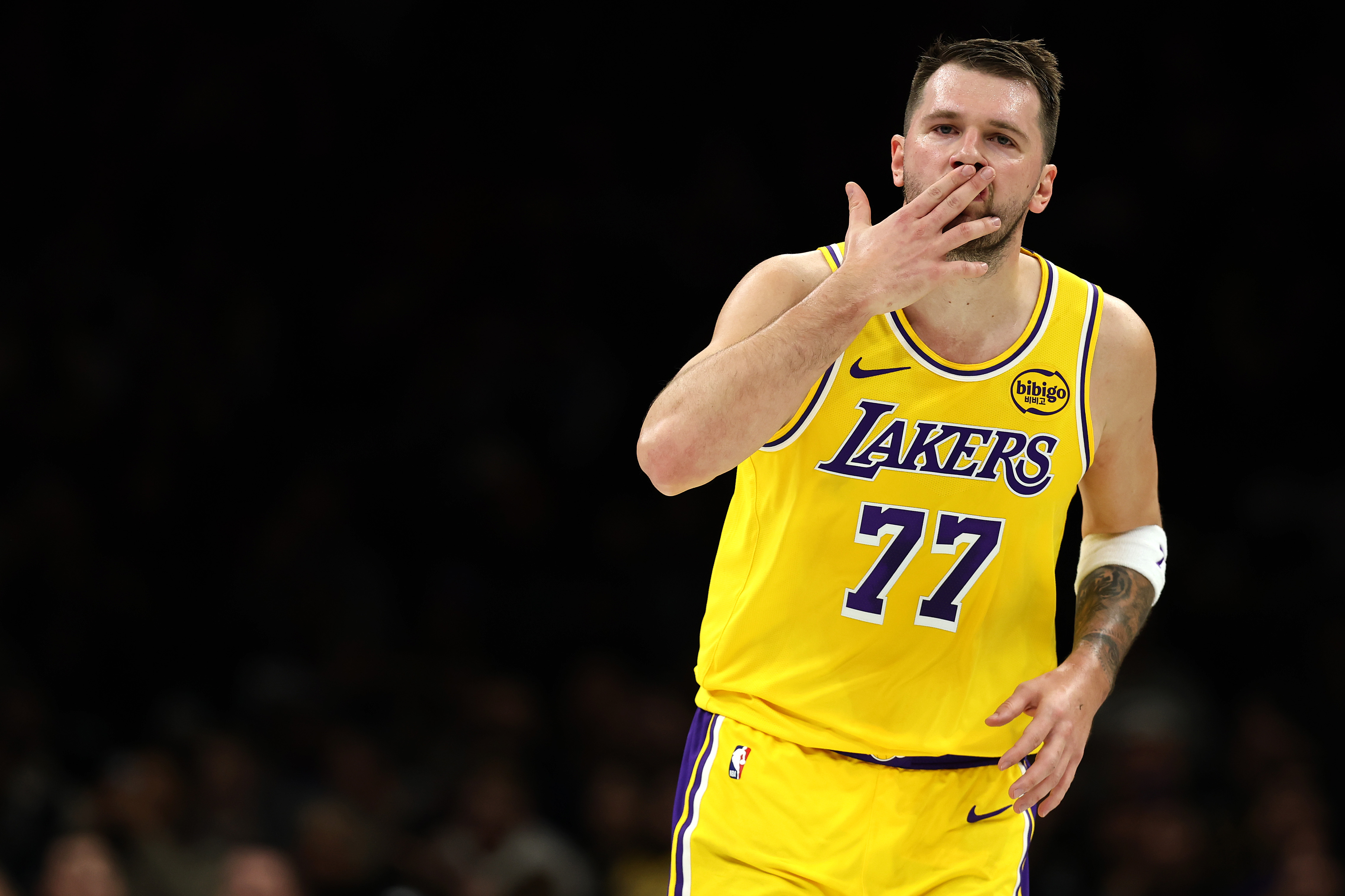 Lakers star Luka Doncic reacts after making a 3-point shot...