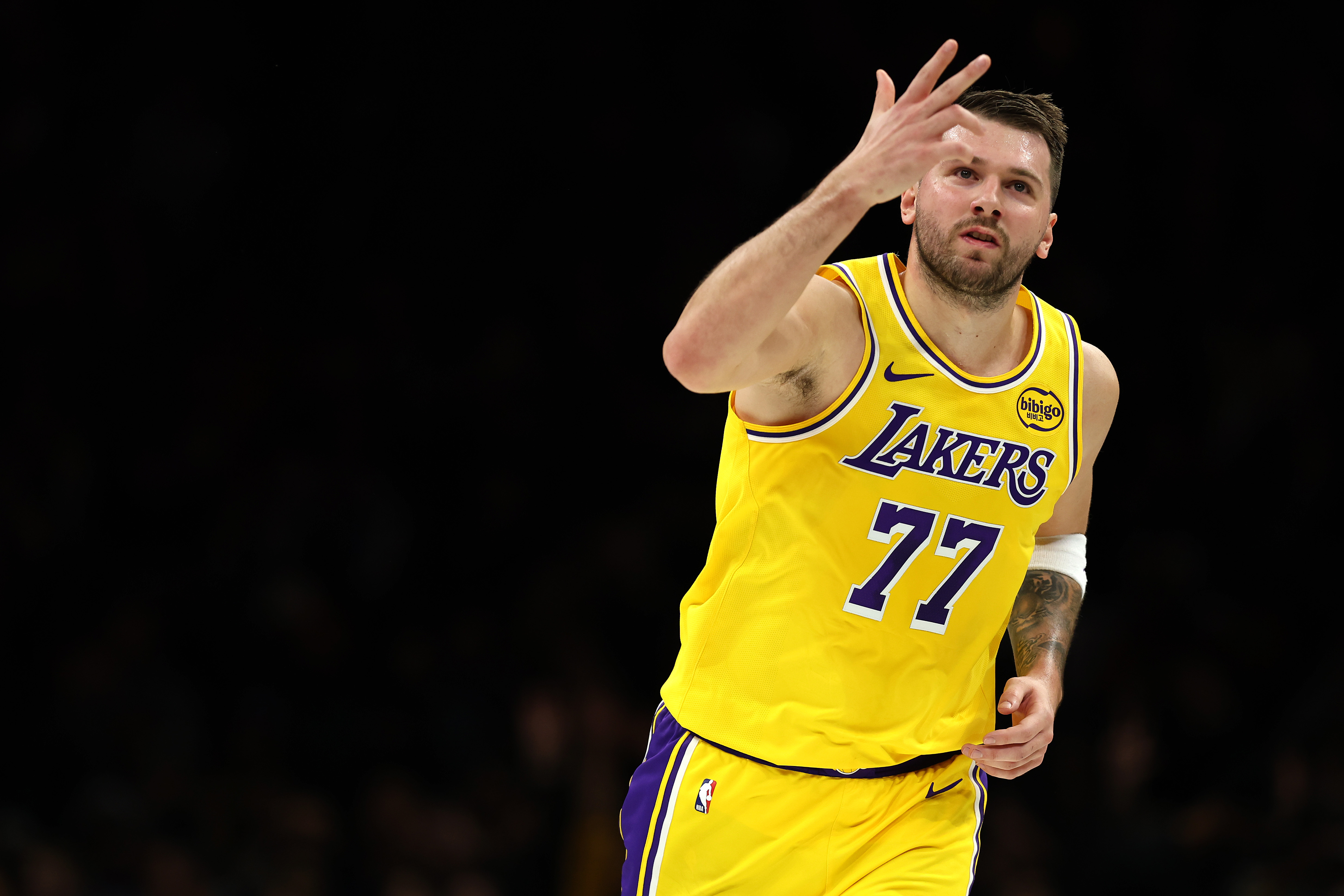 Lakers star Luka Doncic reacts after making a 3-point shot...