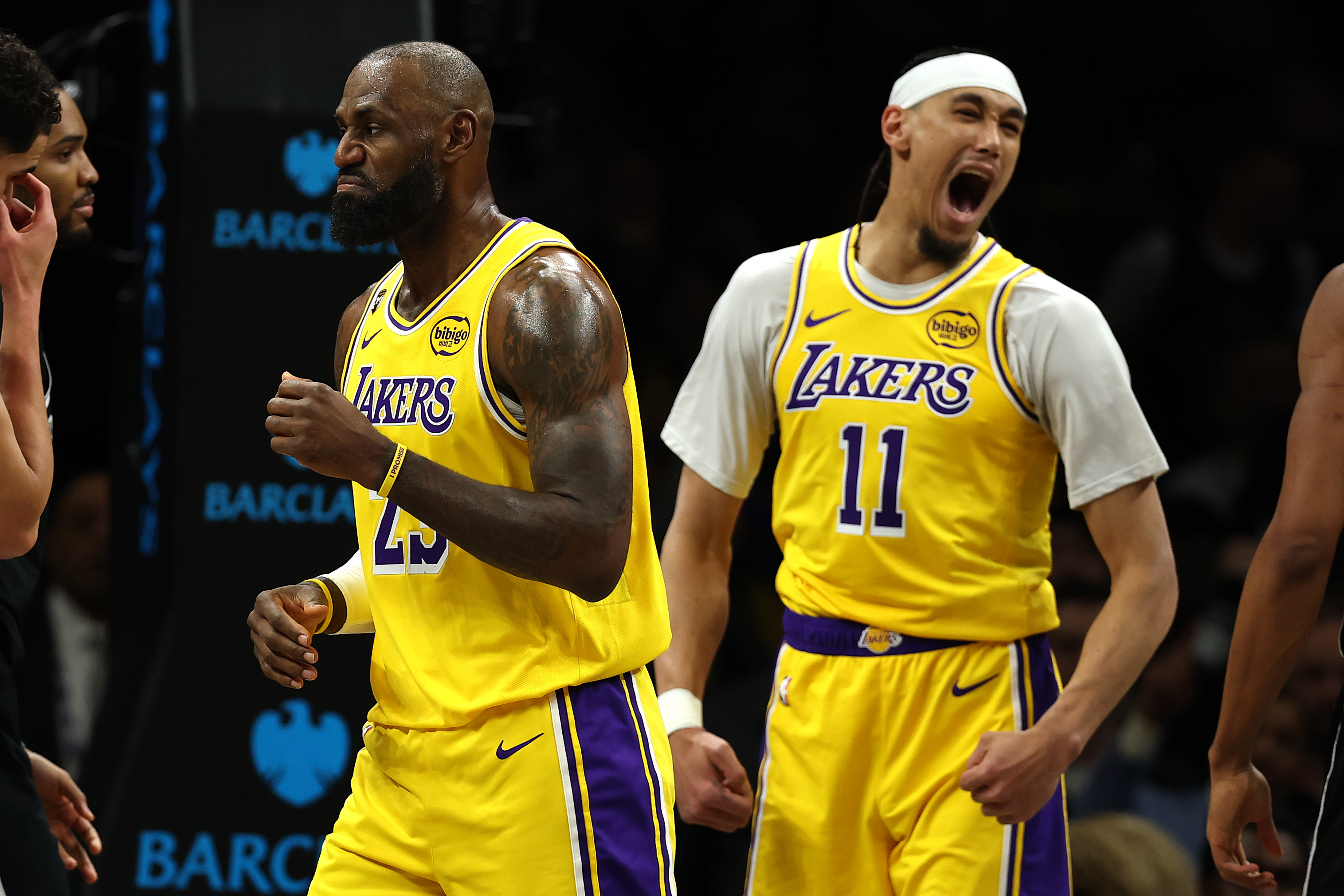 Lakers star LeBron James, left, and center Jaxson Hayes react...