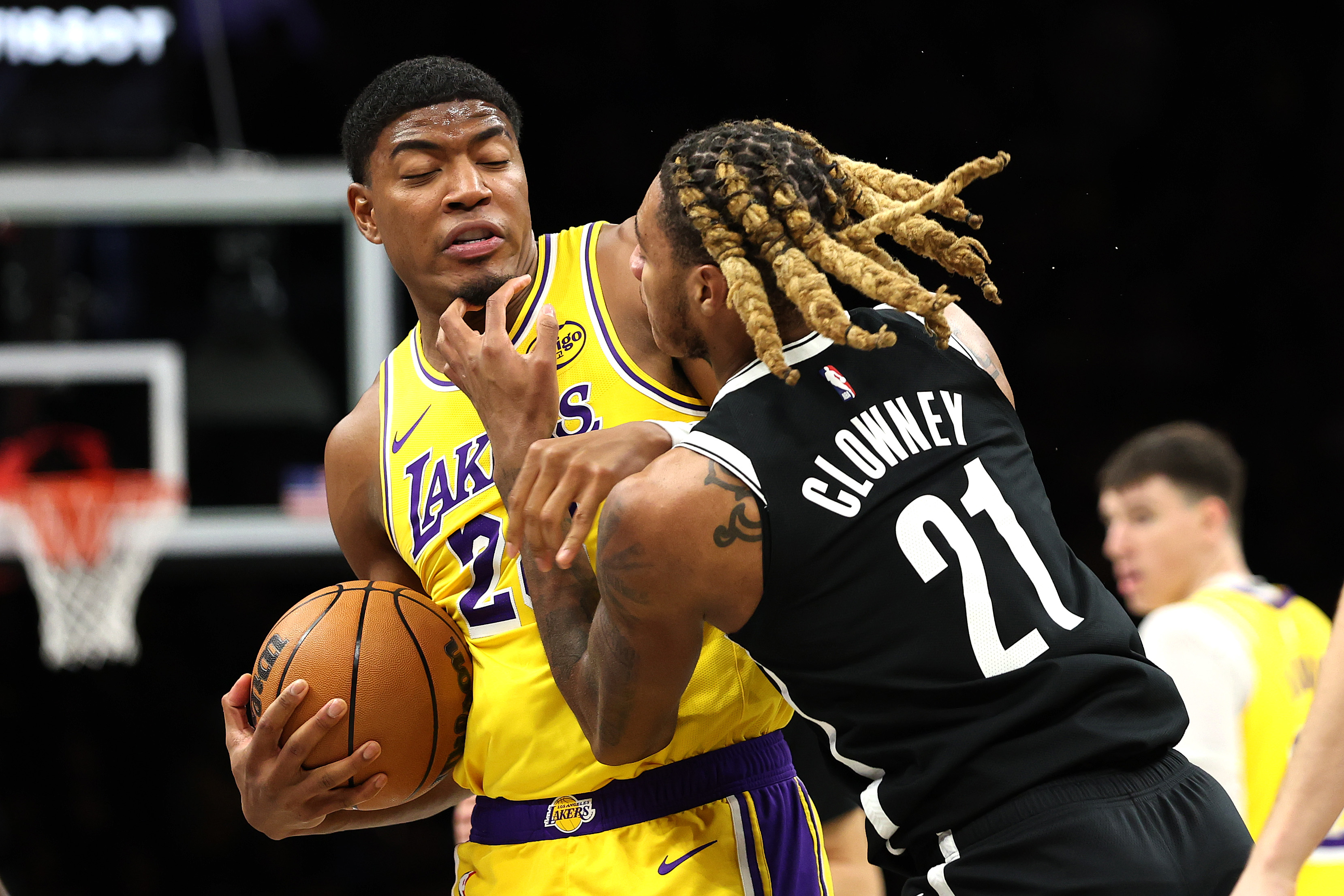 Lakers forward Rui Hachimura, left, shields the ball from the...