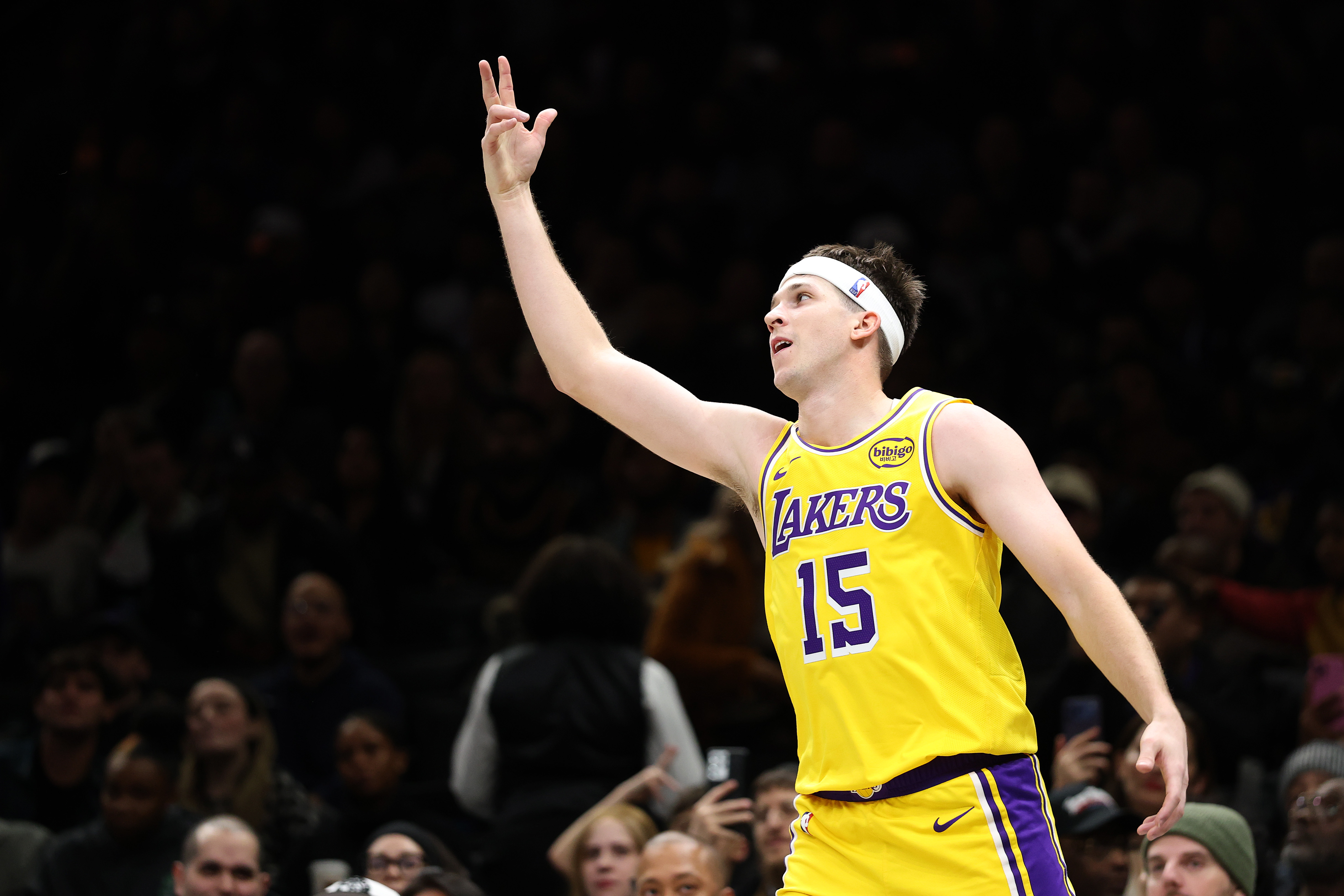 Lakers guard Austin Reaves gestures after making a 3-point shot...
